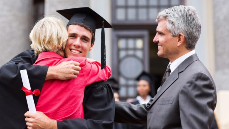 boy hugging his parents at graduation