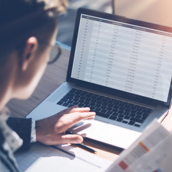 man at his computer spreadsheets work