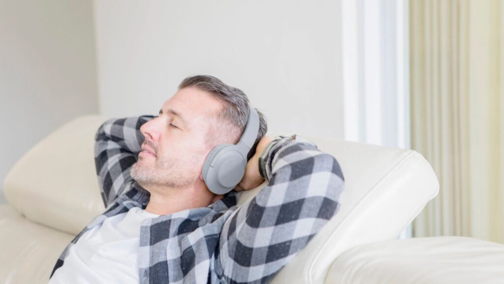 Caucasian Man Relaxing on Sofa with Headphones