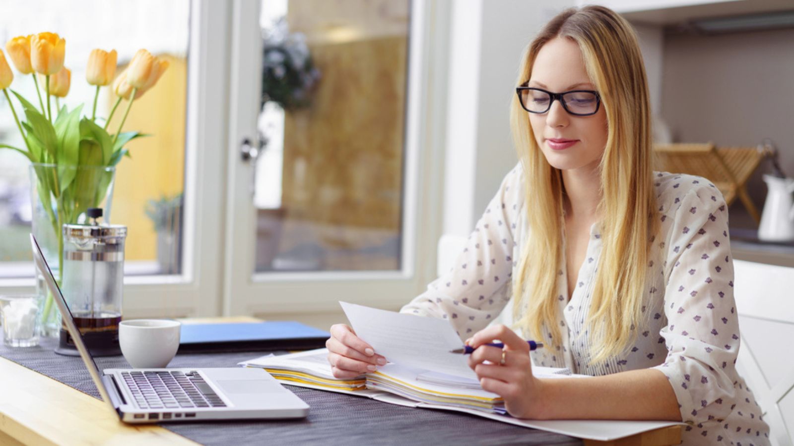 Woman with eyeglasses reviewing documents