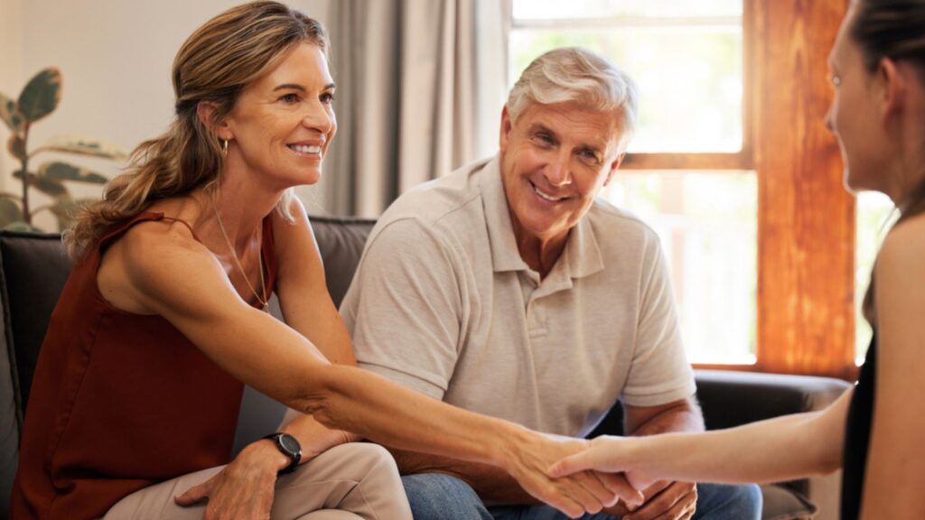 Senior couple, handshake and finance worker welcome, thank you or agreement with consulting with money or retirement savings. Money Concept