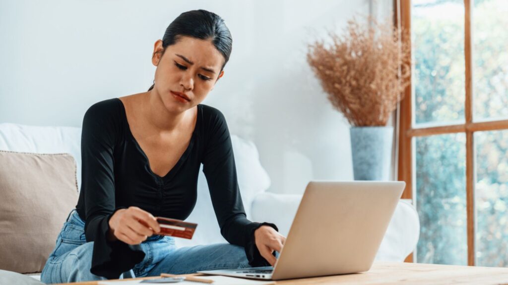 Stressed young woman credit card financial banking problems with laptop inside. Money concept
