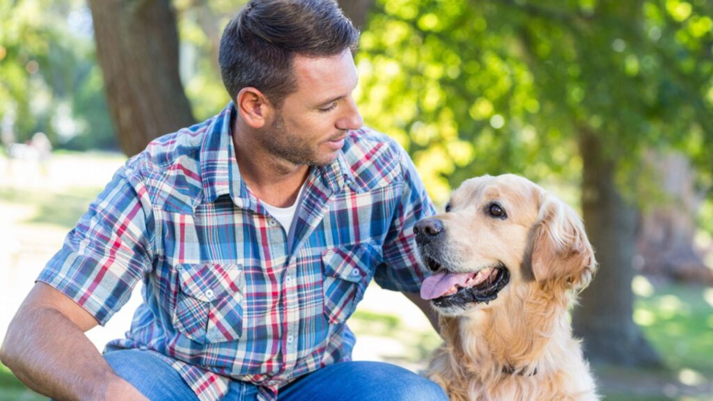 Man with pet dog in park