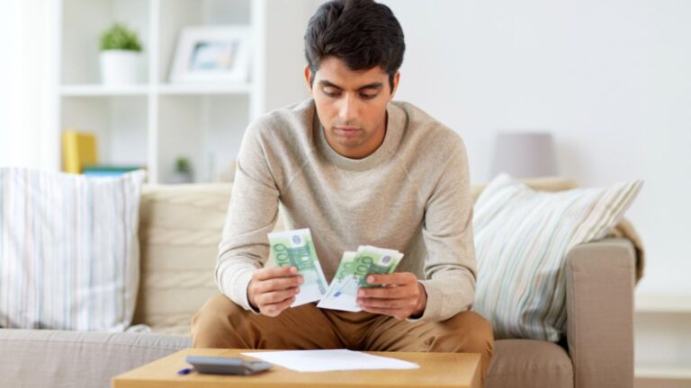 Man counting money at home