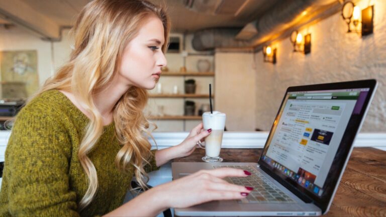 Woman using laptop computer in cafe