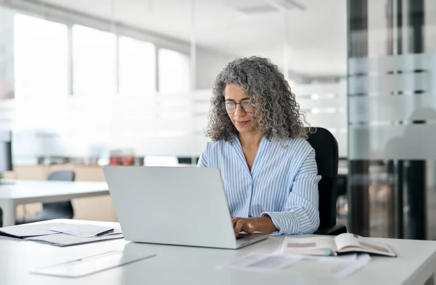 DO NOT REUSE old woman working on her laptop.