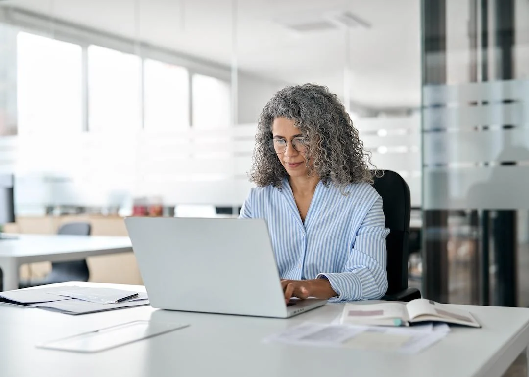 DO NOT REUSE old woman working on her laptop.